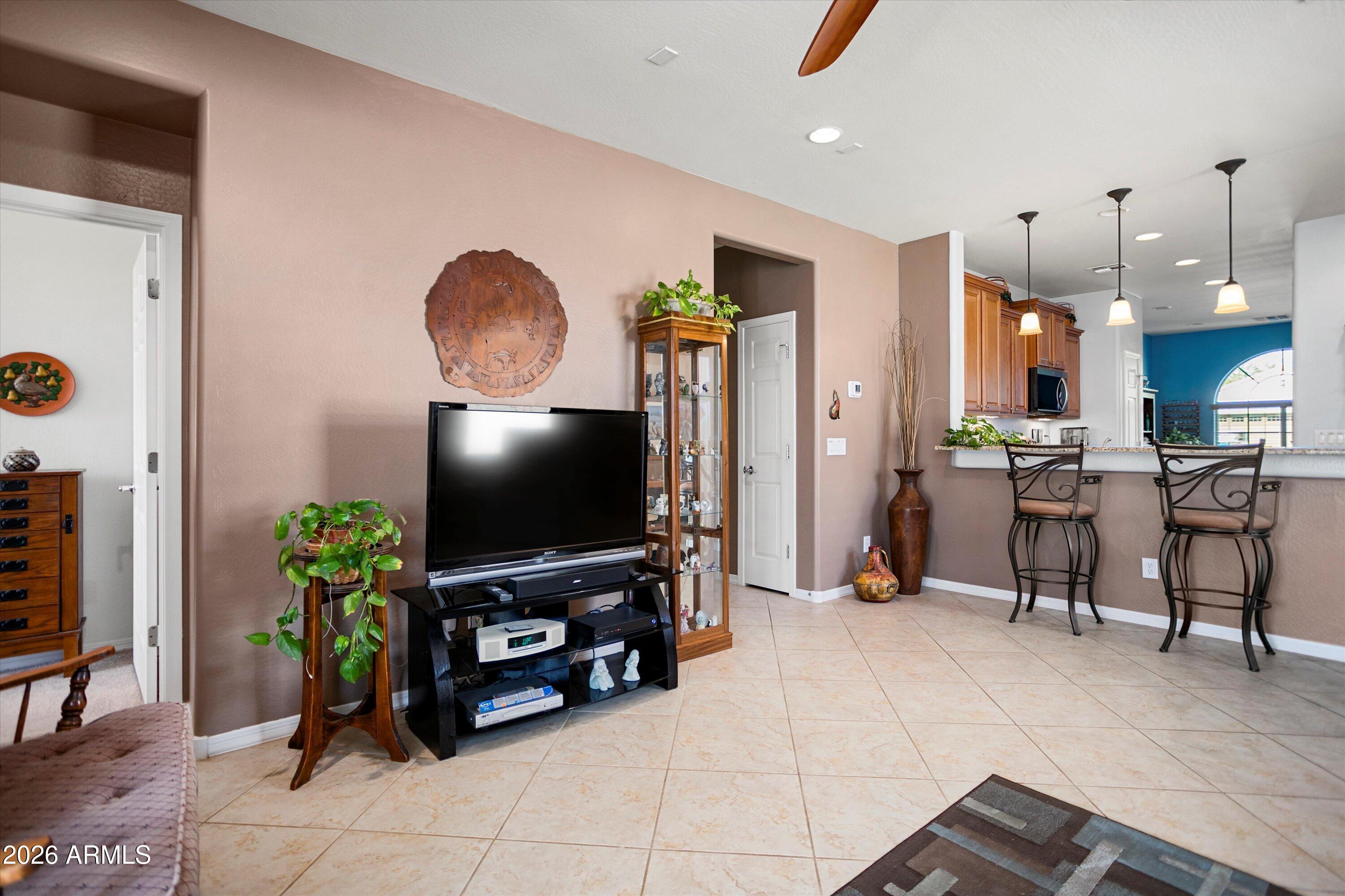 21613 North 261st Avenue Buckeye, AZ 85396 - Photo 14 of 52 a living room with furniture and a flat screen tv
