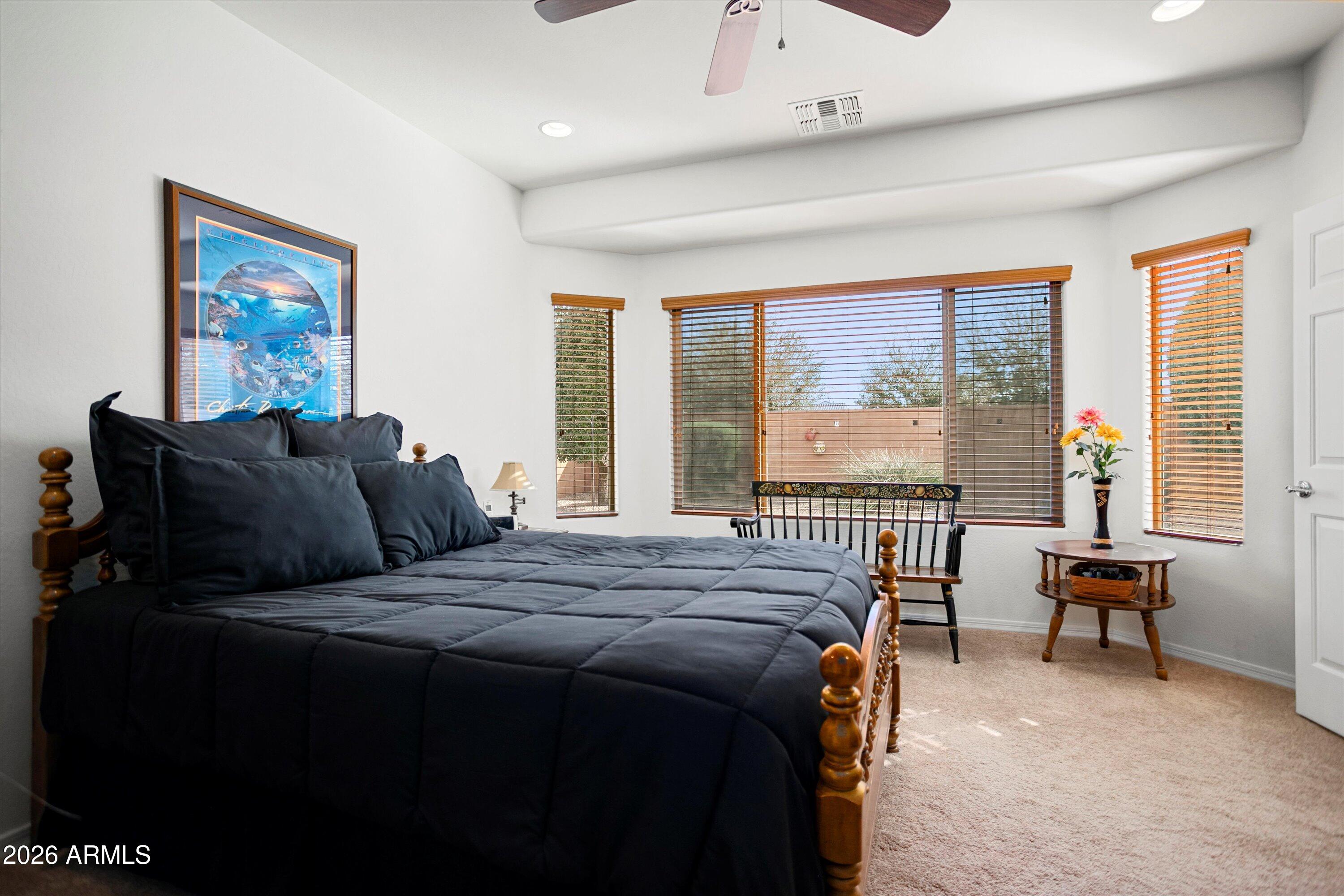21613 North 261st Avenue Buckeye, AZ 85396 - Photo 16 of 52 a bedroom with furniture and a large window
