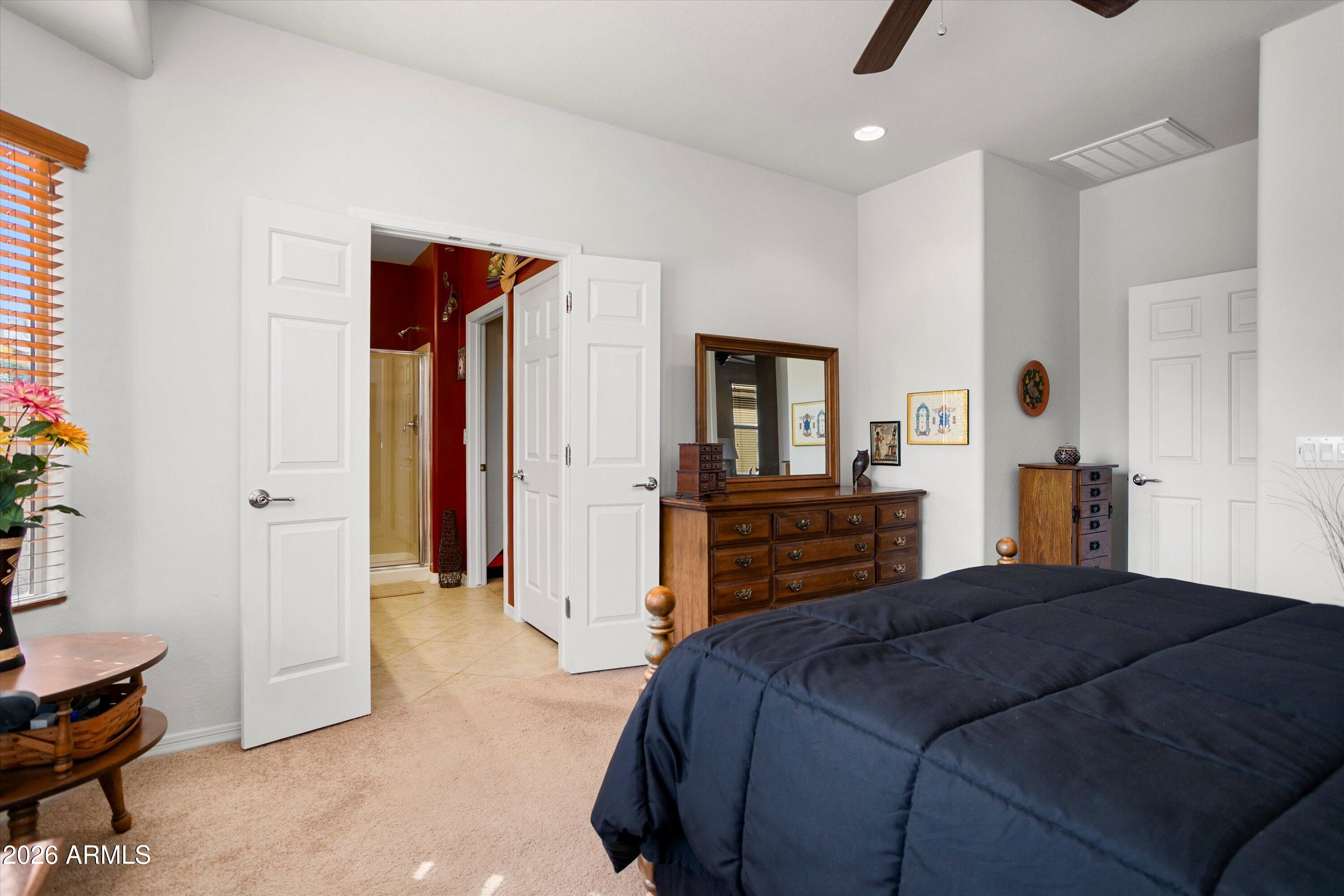 21613 North 261st Avenue Buckeye, AZ 85396 - Photo 17 of 52 a bedroom with a bed and a television in it