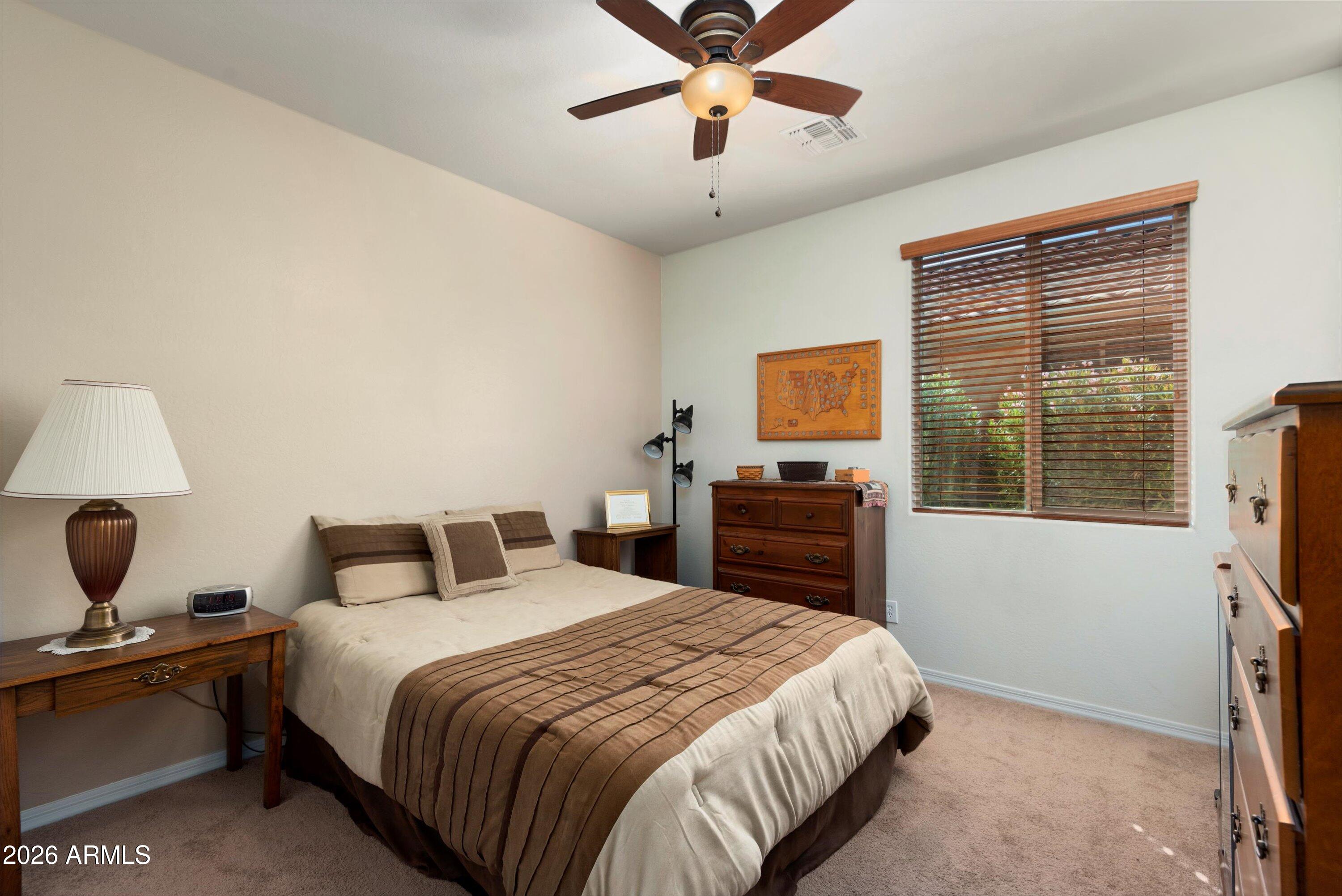 21613 North 261st Avenue Buckeye, AZ 85396 - Photo 20 of 52 a bedroom with a bed and wooden floor