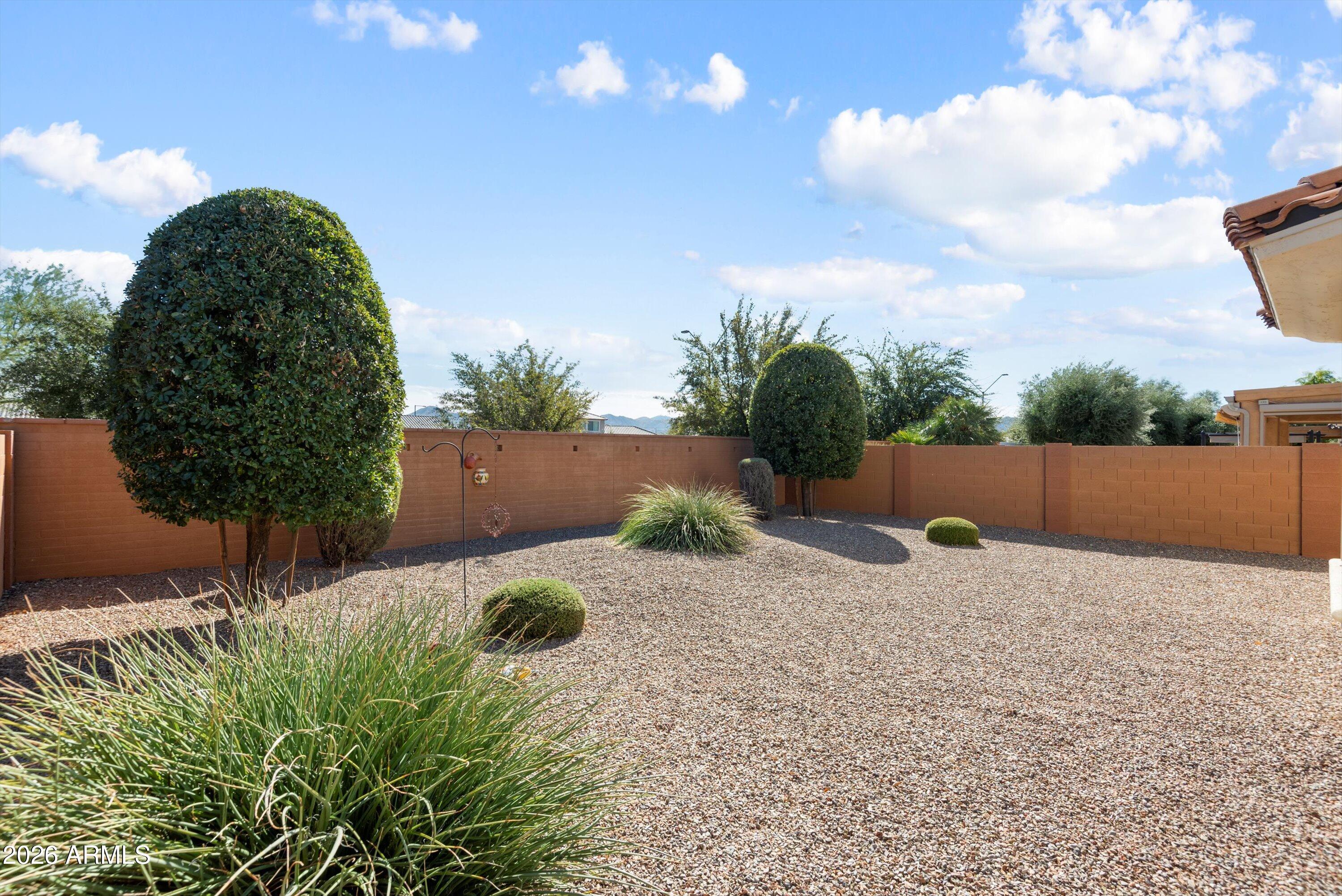 21613 North 261st Avenue Buckeye, AZ 85396 - Photo 26 of 52 a backyard of a house with lots of green space
