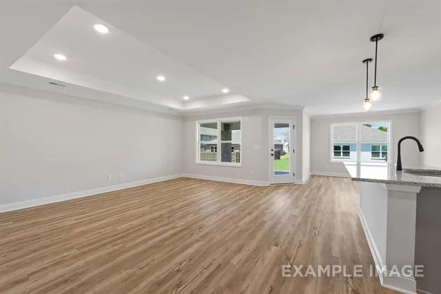 a view of kitchen with kitchen island a sink wooden floor and view living room