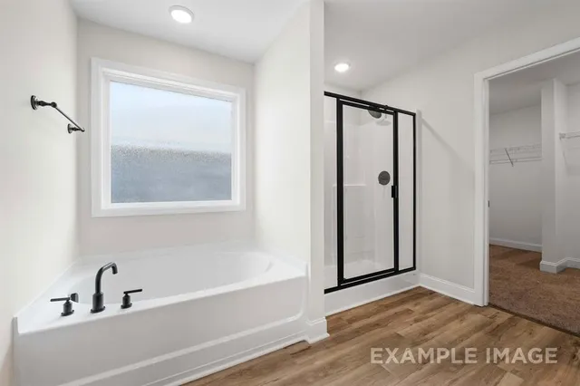 a bathroom with a glass shower door and a bathtub
