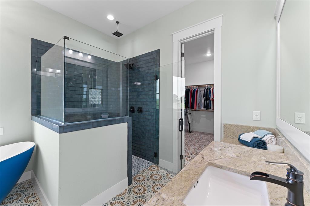 4411 Fm 751 Wills Point Wills Point, TX 75169 - Photo 22 of 40 Bathroom featuring a walk-in shower with glass enclosure, blue subway tile, and a rainfall showerhead