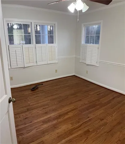 a view of walk in closet with wooden floor