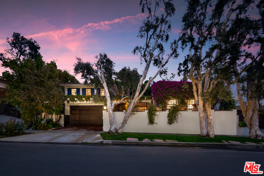 a view of a yard in front of the house with a fountain