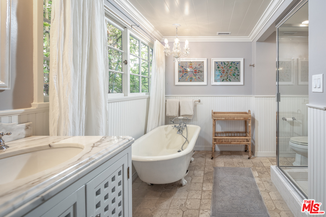 548 Dryad Road Santa Monica, CA 90402 - Photo 17 of 34 a spacious bathroom with a granite countertop sink and a mirror
