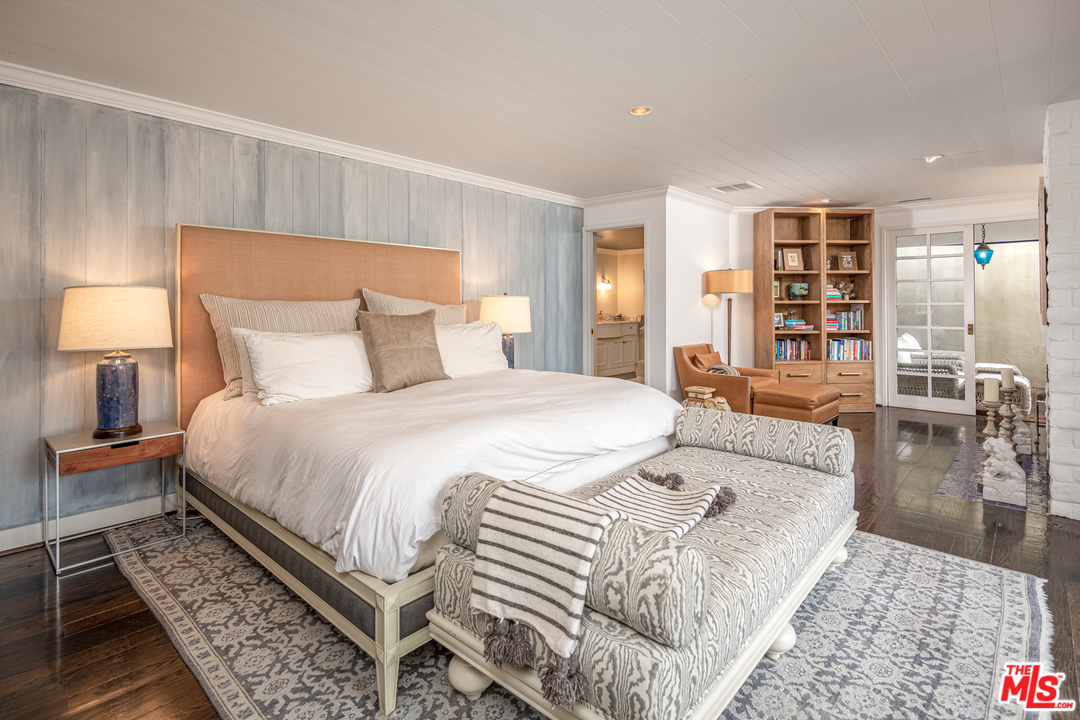 548 Dryad Road Santa Monica, CA 90402 - Photo 19 of 34 a large bedroom with a bed and wooden floor