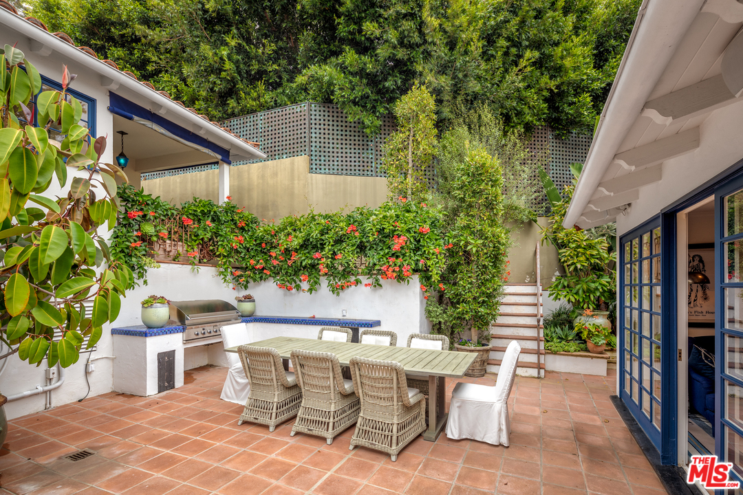548 Dryad Road Santa Monica, CA 90402 - Photo 26 of 34 a view of a patio with table and chairs and potted plants