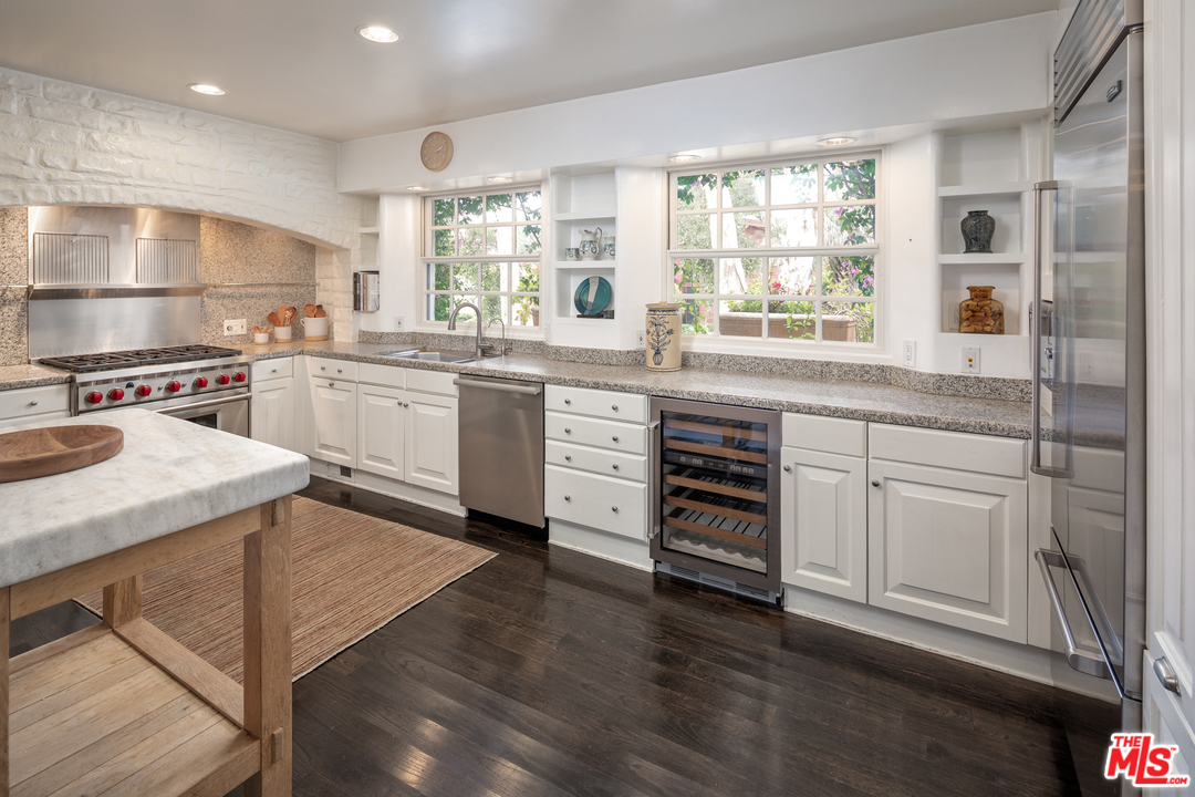 548 Dryad Road Santa Monica, CA 90402 - Photo 7 of 34 a kitchen with granite countertop white cabinets and white appliances