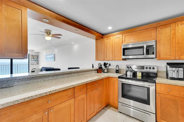 a kitchen with granite countertop a sink stainless steel appliances and cabinets