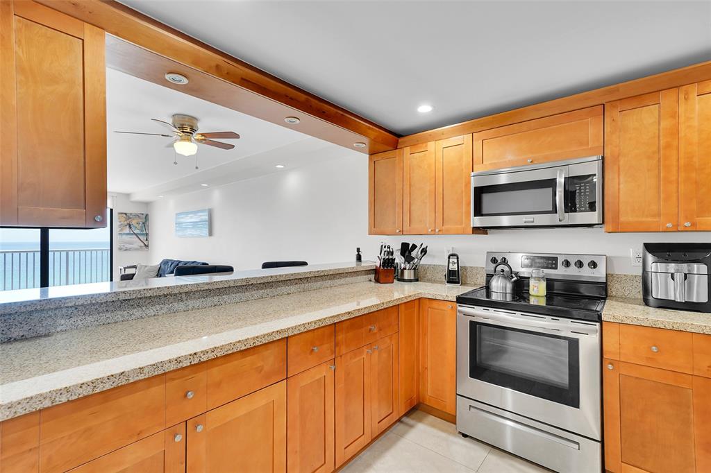 400 North Surf Road, Unit 703 Hollywood, FL 33019 - Photo 17 of 50 a kitchen with granite countertop a sink stainless steel appliances and cabinets