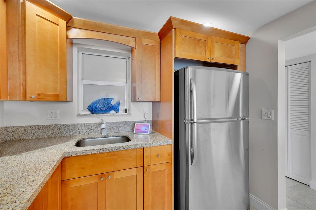 400 North Surf Road, Unit 703 Hollywood, FL 33019 - Photo 20 of 50 a kitchen with stainless steel appliances granite countertop a refrigerator and a sink