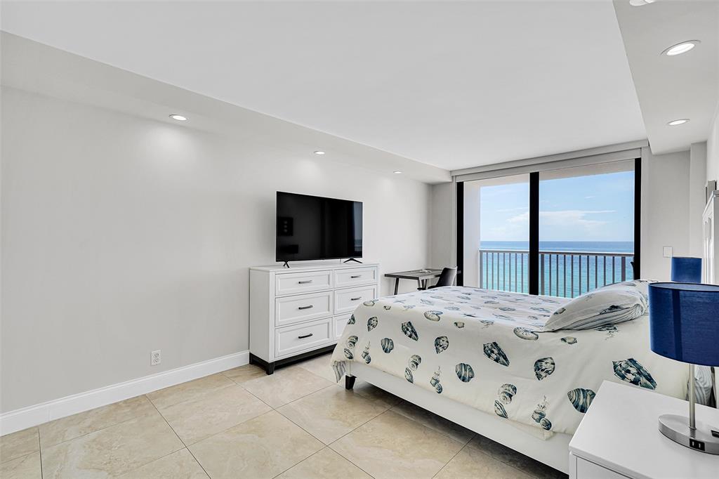400 North Surf Road, Unit 703 Hollywood, FL 33019 - Photo 32 of 50 a bedroom with a bed and a flat screen tv