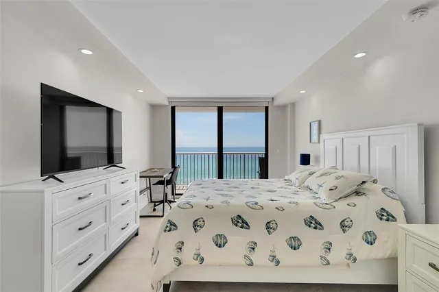 a bedroom with a bed and a flat screen tv in it