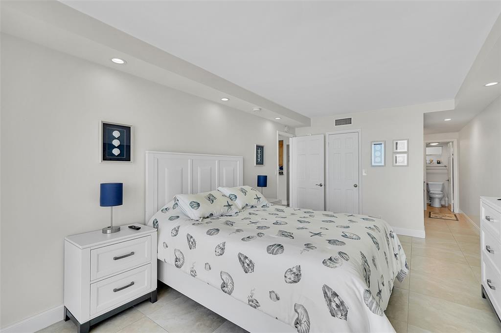 400 North Surf Road, Unit 703 Hollywood, FL 33019 - Photo 35 of 50 a spacious bedroom with a bed and a walk in closet