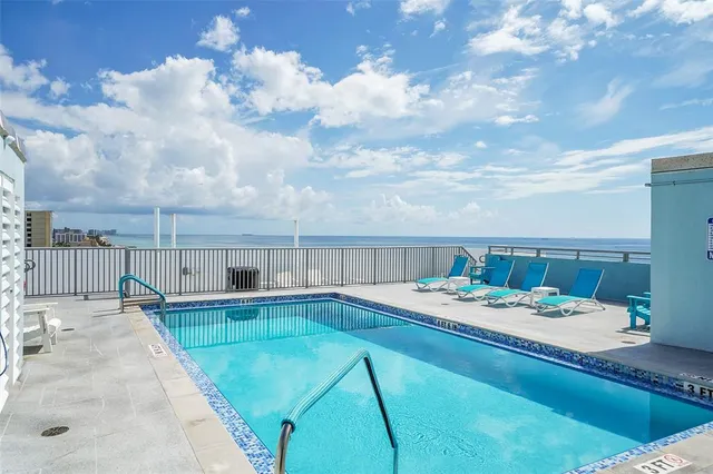 a view of a house with swimming pool and sitting area