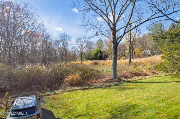 a backyard of a house with large trees