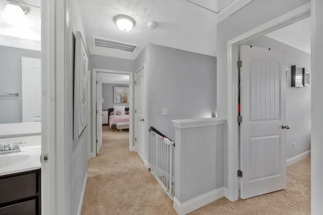 a view of a hallway with closet and a livingroom view