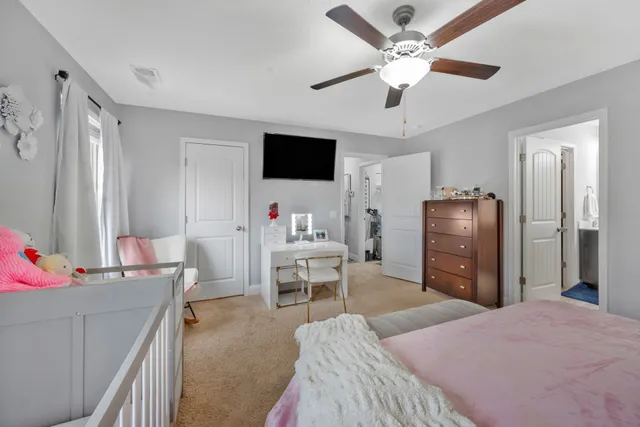 a living room with furniture a ceiling fan and a window