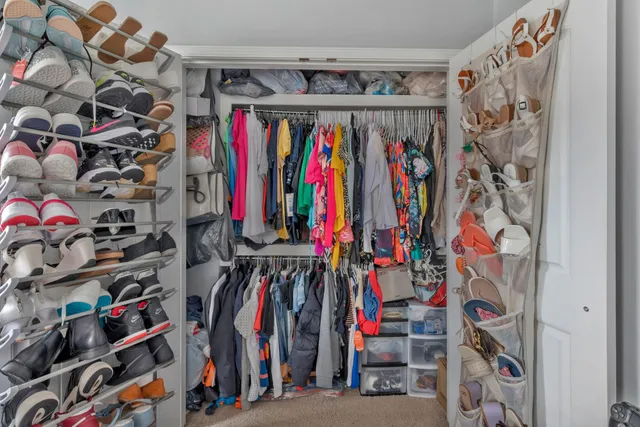 a view of walk in closet with clothes