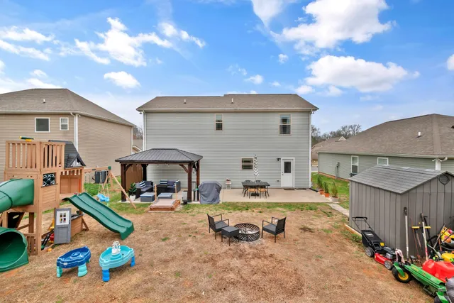 a view of house with outdoor space and a car parked in front of it