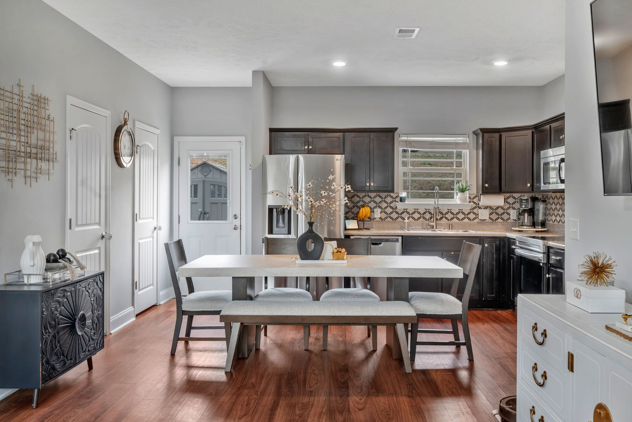 1043 Berra Drive Springfield, TN 37172 - Photo 7 of 33 a kitchen with stainless steel appliances kitchen island granite countertop a dining table chairs and a refrigerator