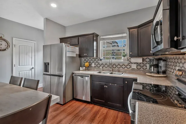 a kitchen with a refrigerator stove and sink