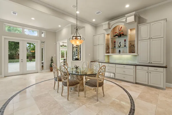 a large kitchen with a table and chairs