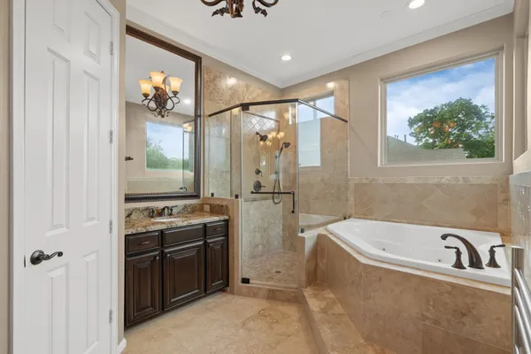 a bathroom with a tub sink and mirror
