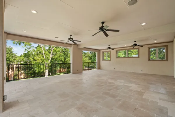 a kitchen with white cabinets appliances a sink and a window