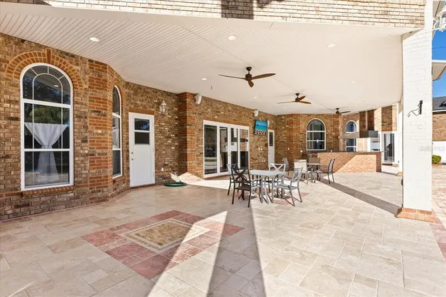 a large kitchen with stainless steel appliances granite countertop a sink and cabinets