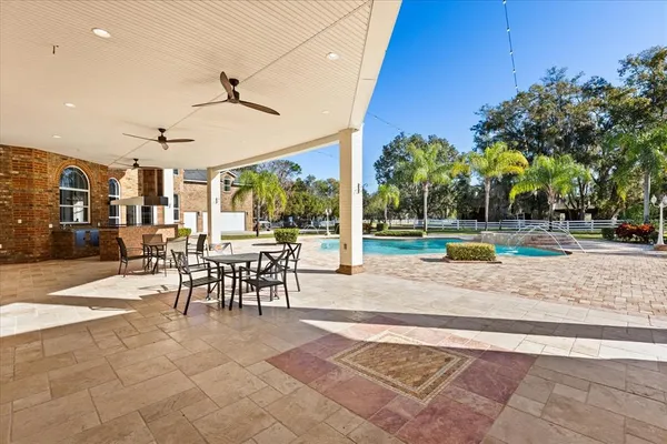 a large kitchen with stainless steel appliances granite countertop a sink and cabinets