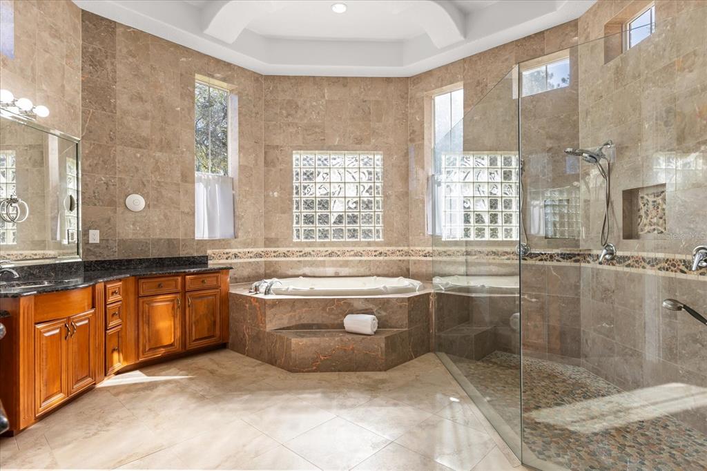 1501 Lake Markham Road Sanford, FL 32771 - Photo 62 of 93 a large bathroom with a granite countertop tub a sink and a large mirror