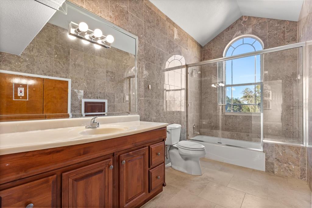 1501 Lake Markham Road Sanford, FL 32771 - Photo 74 of 93 a spacious bathroom with a granite countertop sink a toilet a mirror and shower