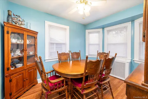 a dining room with furniture a chandelier and wooden floor