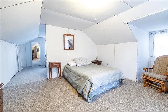 a spacious bedroom with a bed and a couch