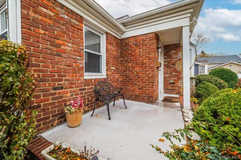 a view of a brick wall with an outdoor space