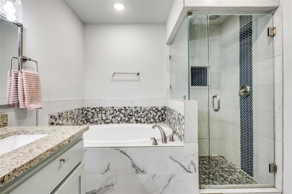 409 West Johnson Street Denison, TX 75020 - Photo 18 of 25 a bathroom with a granite countertop sink and a bathtub