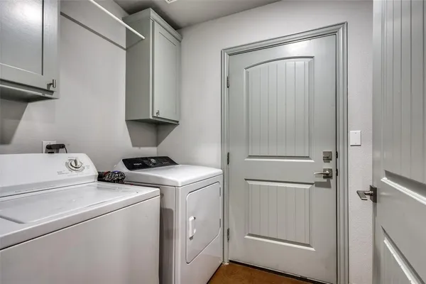 a view of storage and utility room with washer and dryer