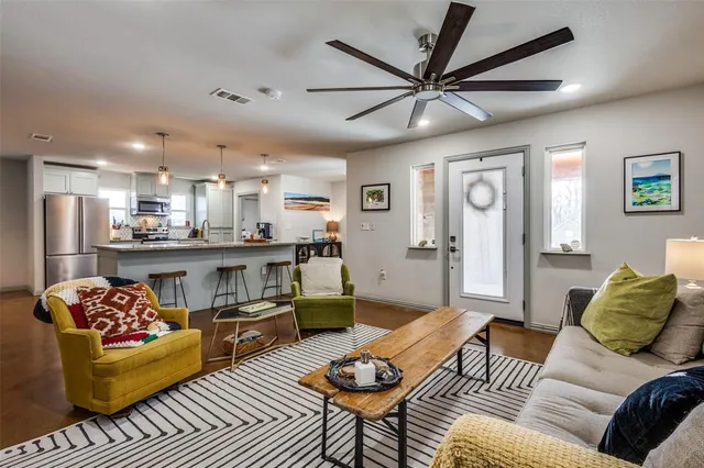 a living room with furniture and kitchen view