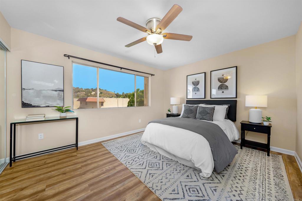 6775 Alvarado Road, Unit 7 San Diego, CA 92120 - Photo 12 of 24 a spacious bedroom with a large bed and a chandelier