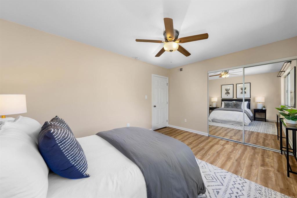 6775 Alvarado Road, Unit 7 San Diego, CA 92120 - Photo 14 of 24 a bedroom with a large bed and a chandelier
