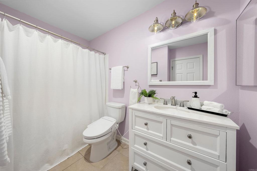 6775 Alvarado Road, Unit 7 San Diego, CA 92120 - Photo 15 of 24 a bathroom with a granite countertop sink a toilet and a mirror
