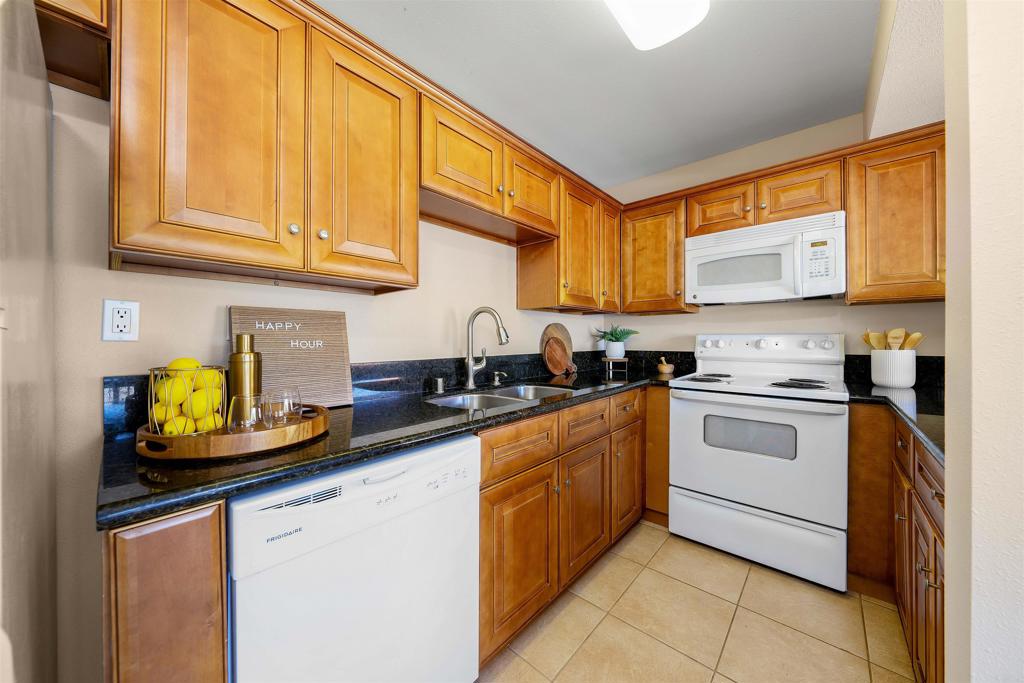6775 Alvarado Road, Unit 7 San Diego, CA 92120 - Photo 9 of 24 a kitchen with stainless steel appliances granite countertop a stove sink and cabinets