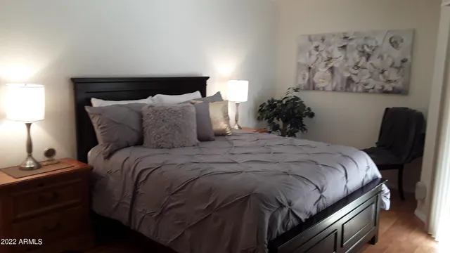 a large bed sitting in a bedroom next to a lamp