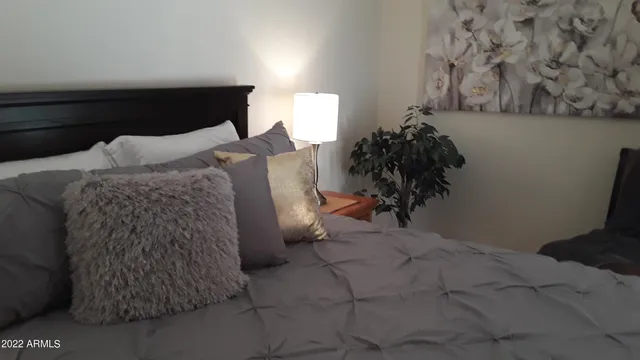 a bed room with a bed and a potted plant