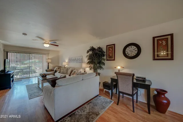 a living room with furniture and wooden floor