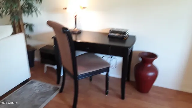 a workspace with furniture and wooden floor