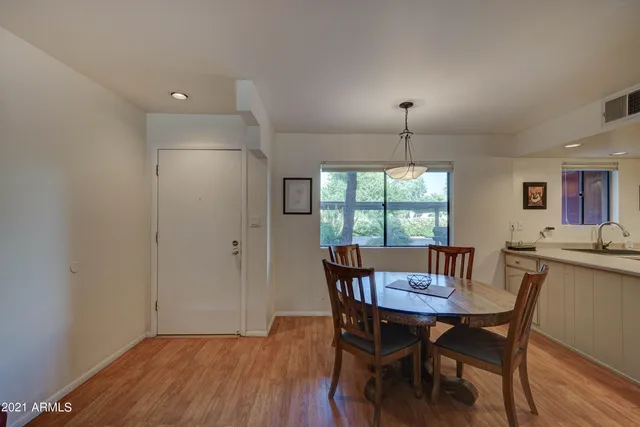 a view of a dining room with furniture window and wooden floor
